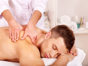 Man getting relaxing massage in spa.